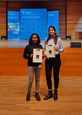 Photo of PhDs Shweta Sharma and Rinu Chacko holding their awards