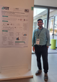 Asad Asadli standing in front of his poster on "Development of Catalyst Bed Concepts for Induction Heating for Emission Control"